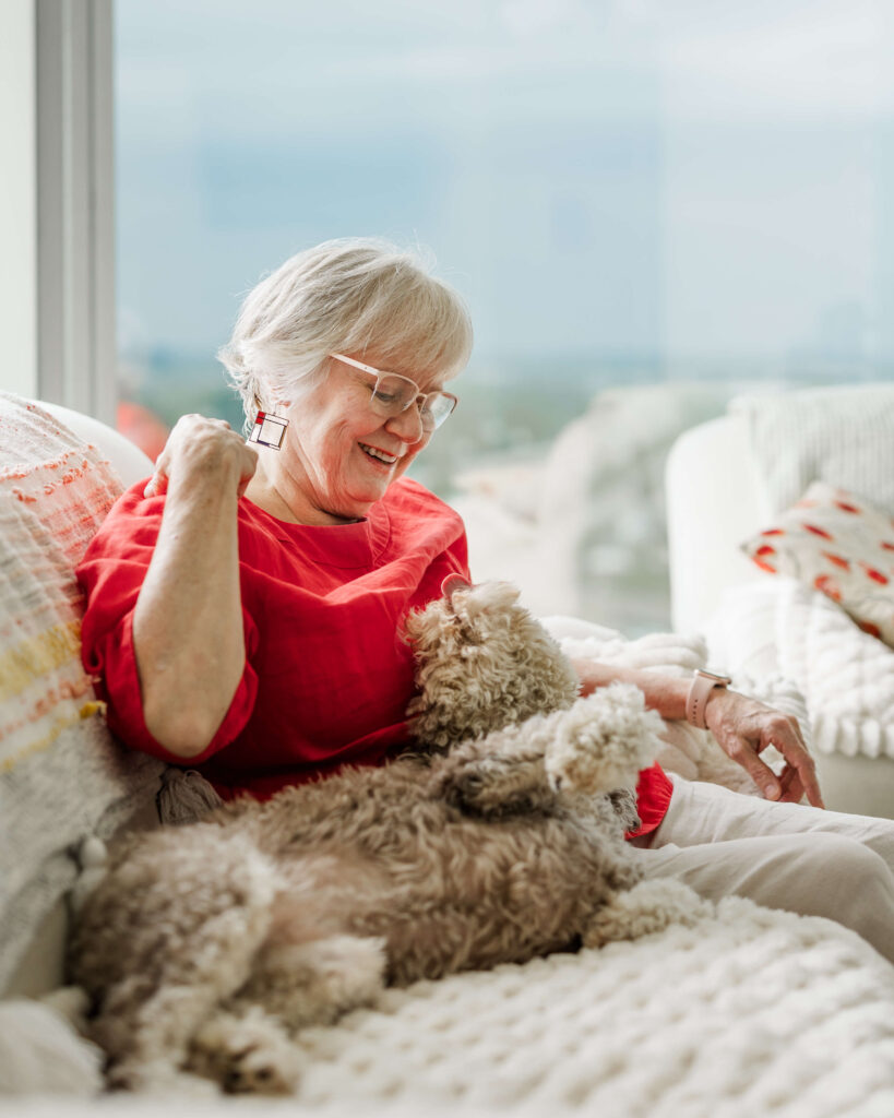 Dog owner bonding with doodle after in-home dog training in Grand Haven Michigan
