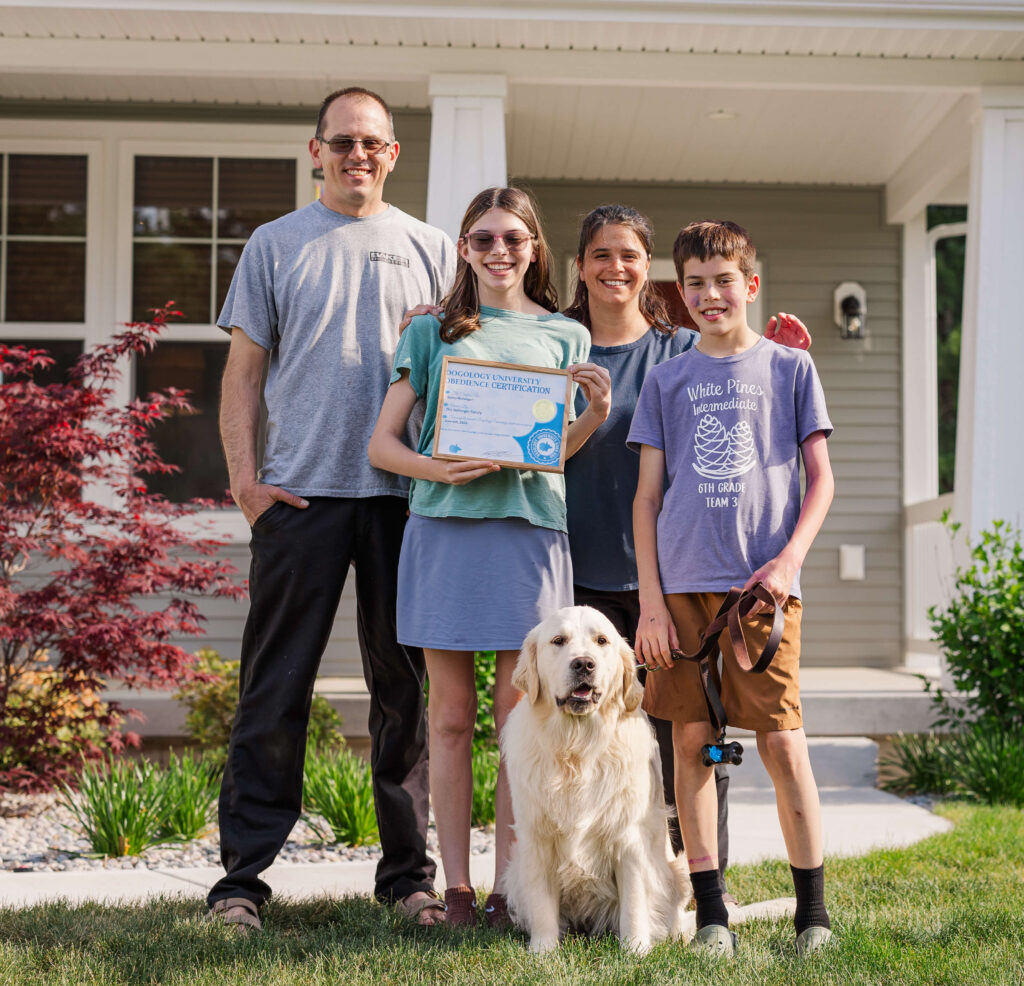 Family celebrating successful completion of private dog training with their Golden Retriever in Grand Haven Michigan