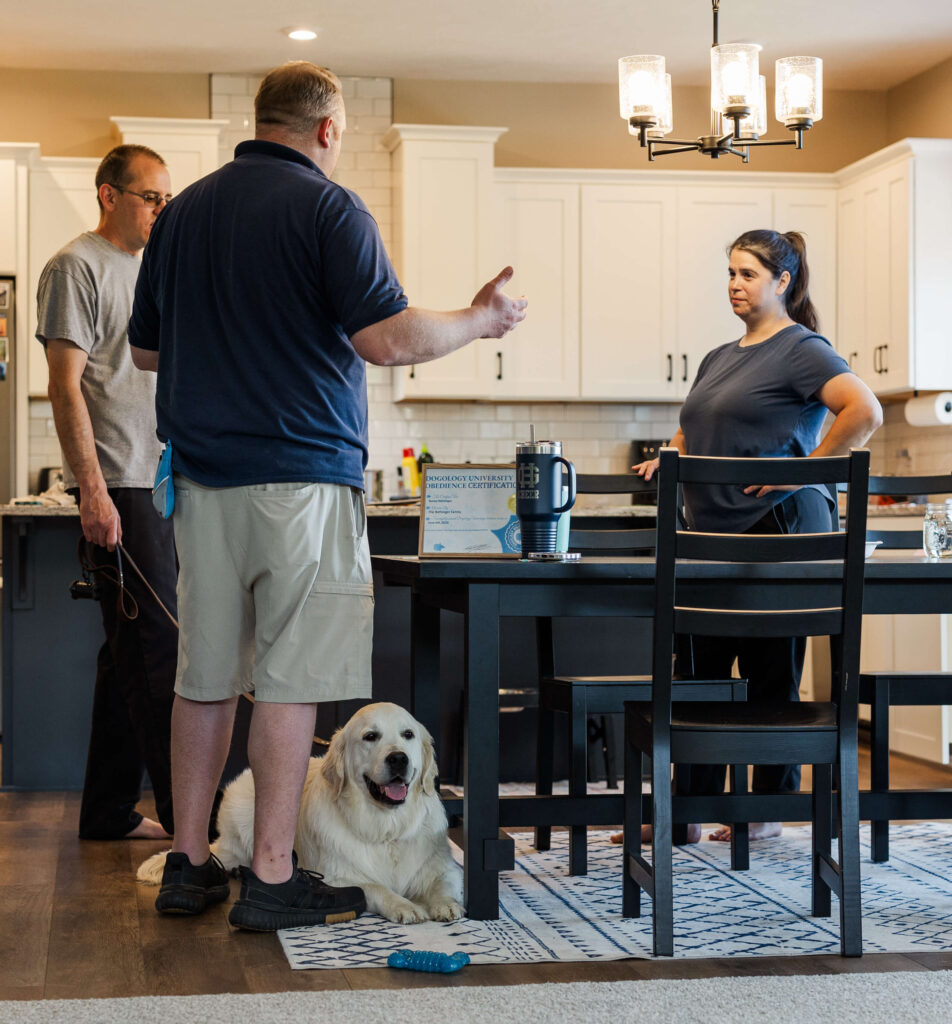Dog owners learning practical dog training skills during a private in-home lesson in Grand Haven Michigan